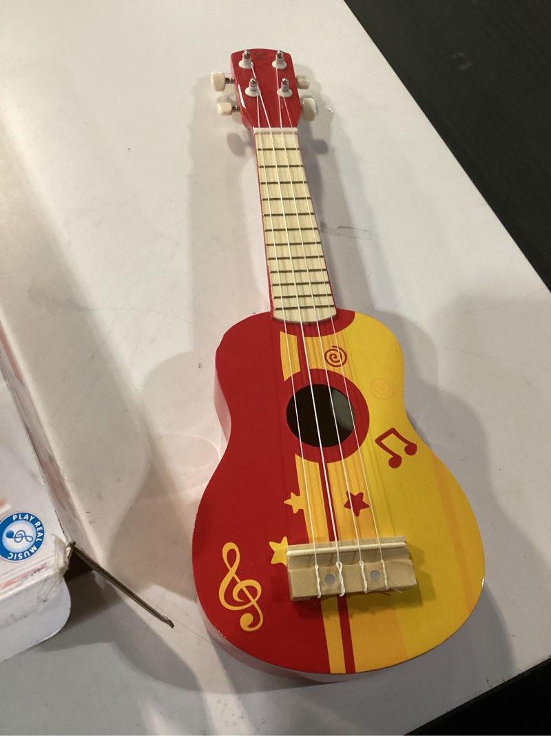 Condition photo showing Good Condition for hape kid's wooden toy ukulele, red