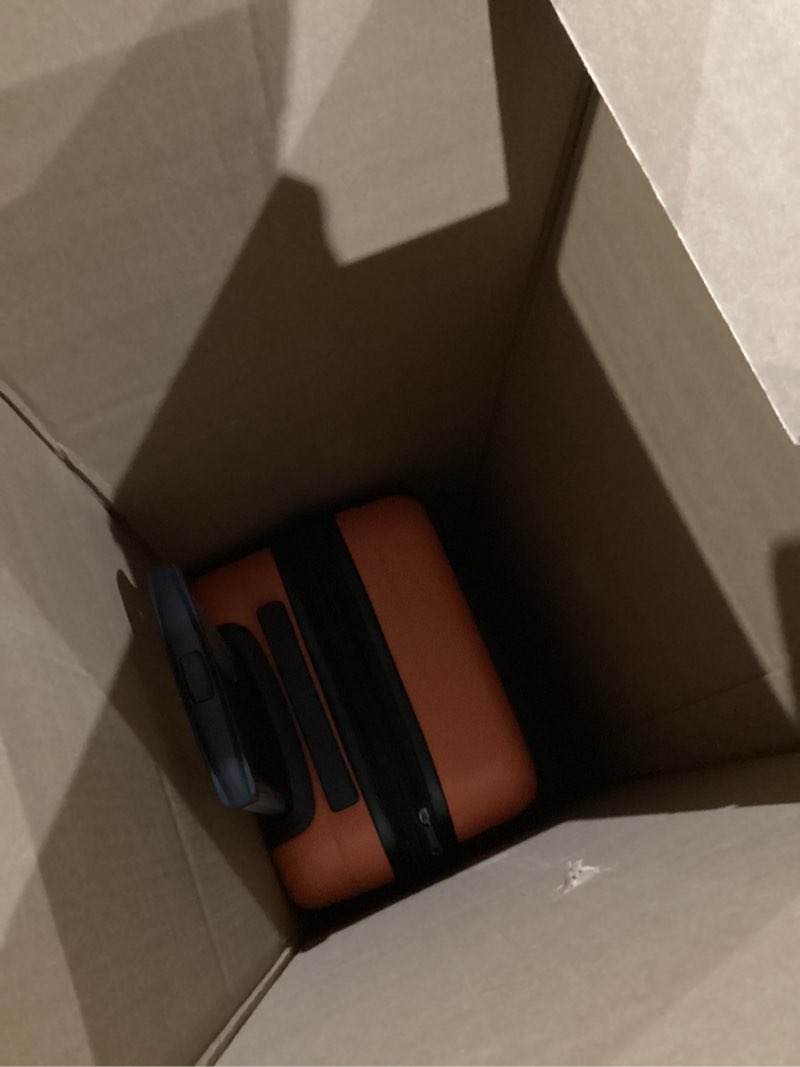 Condition photo showing As Is for amazon basics 21" hardside carry-on luggage, hardshell suitcase with wheels, expandable for up to 25% more space, with scratch-resistant surface, four multi-directional wheels, orange orange carry-on