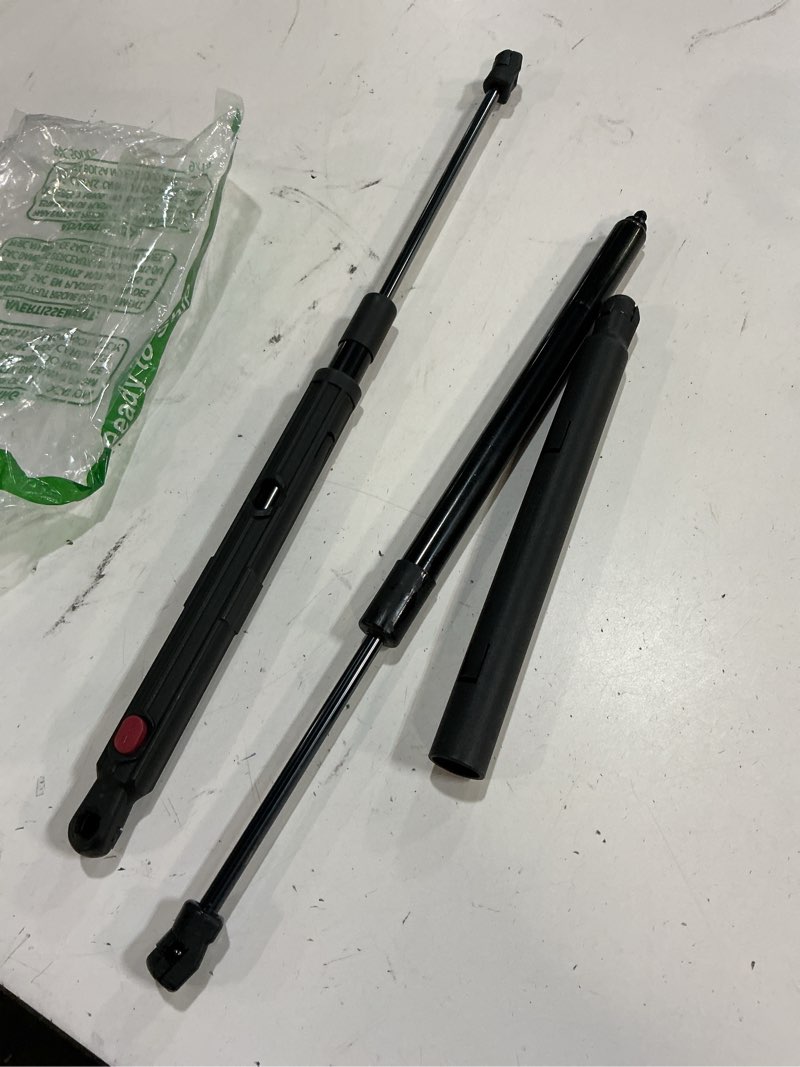 Condition photo showing As Is for trunk lift support struts