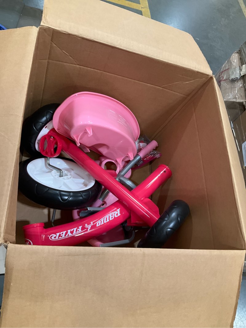 Condition photo showing As Is for radio flyer pink rider trike, ages 2.5-5, adjustable seat, steel construction, quiet ride wheels, storage bin, comfort grip handlebars, tricycle for toddlers, amazon exclusive