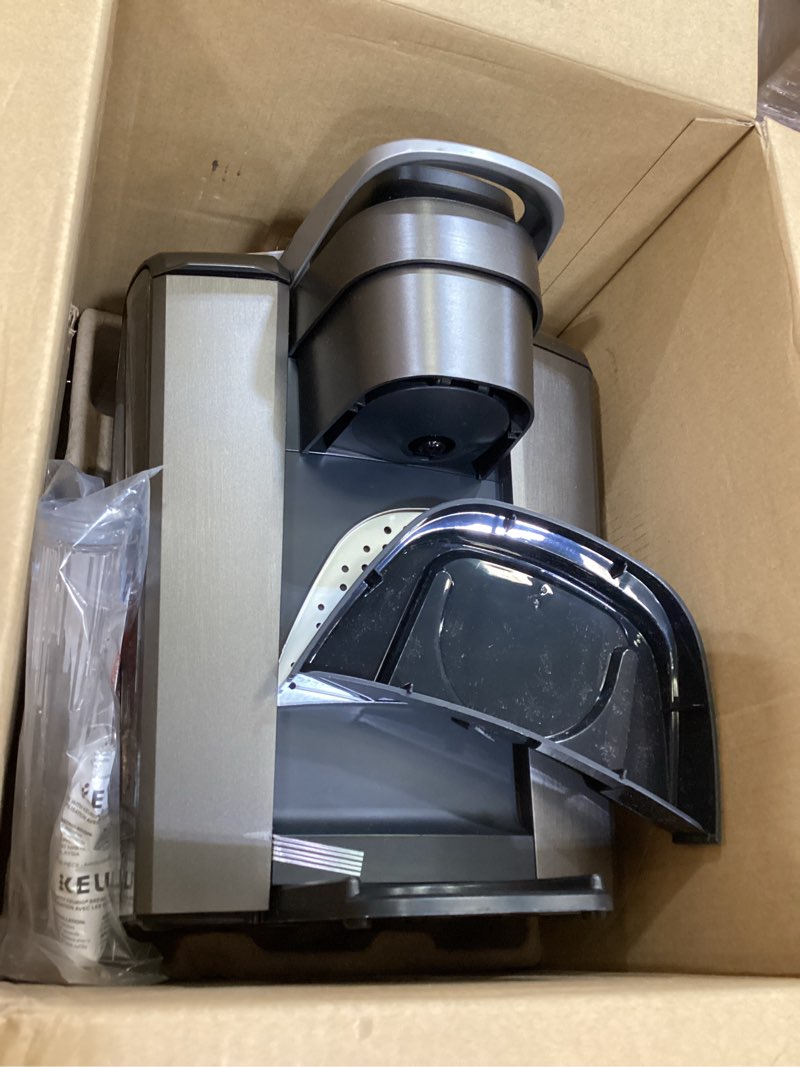 Condition photo showing As Is for keurig k-elite single serve k-cup pod coffee maker, with strength and temperature control, iced coffee capability, 8 to 12oz brew size, programmable, brushed slate