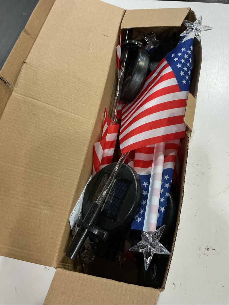 Condition photo showing Good Condition for 8 pack solar american flag lights outdoor, 4th of july decorations outdoor, waterproof solar flag patriotic lights for yard, garden, pathway, independence day, 250th anniversary (red white and blue) red white and blue 8 pack