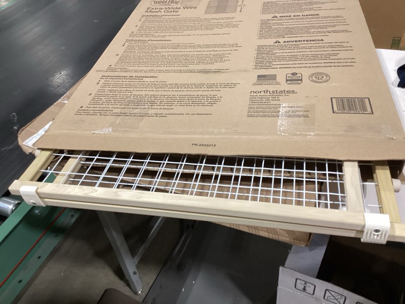 Condition photo showing As Is for wide wire mesh pet gate-color:white