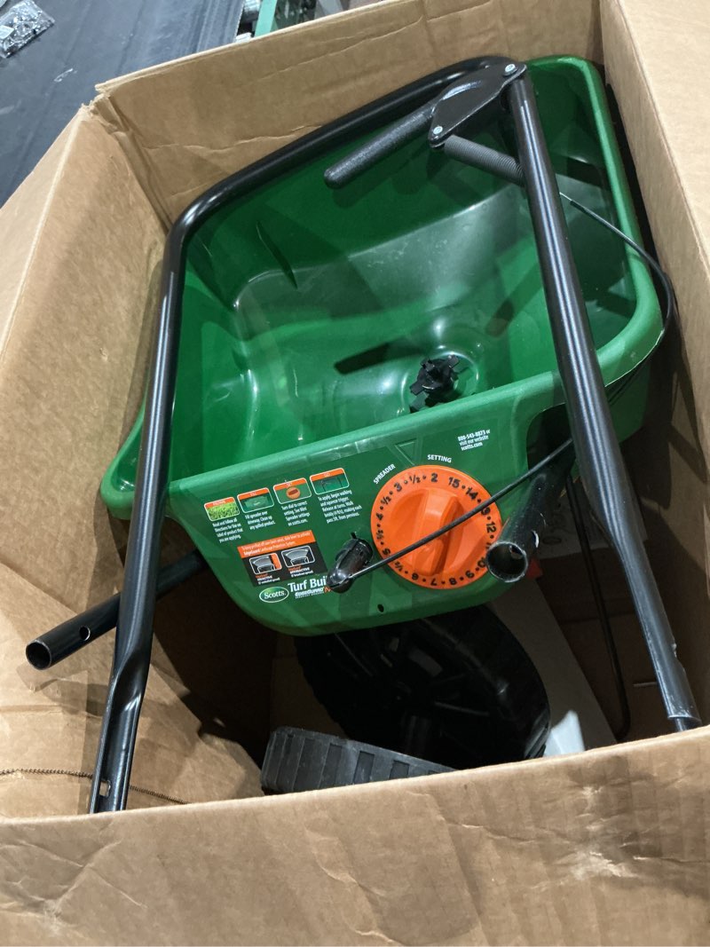 Condition photo showing As Is for scotts turf builder edgeguard mini broadcast spreader - spreads grass seed, fertilizer and salt - holds up to 5,000 sq. ft. of scotts grass seed or fertilizer products