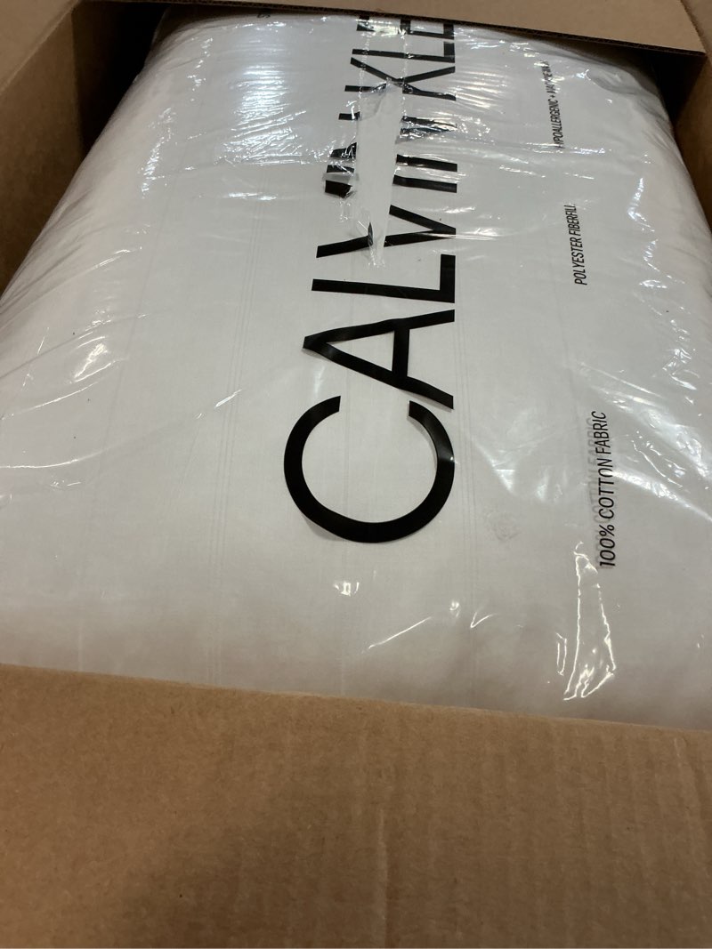 Condition photo showing New/Like New for calvin klein almost down bed pillow, 100% cotton woven stripe cover, firm support standard/queen bed pillow, 20 in x 28 in, white standard/queen (pack of 1) white