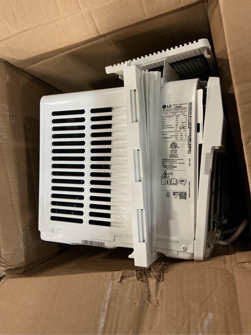 Condition photo showing As Is for lg 6,000 btu window air conditioner, cools 250 sq.ft. (10' x 25' room size), quiet operation, electronic control with remote, 2 cooling & fan speeds, 2-way air deflection, auto restart, 115v 6000 btu electronic & standard bright white