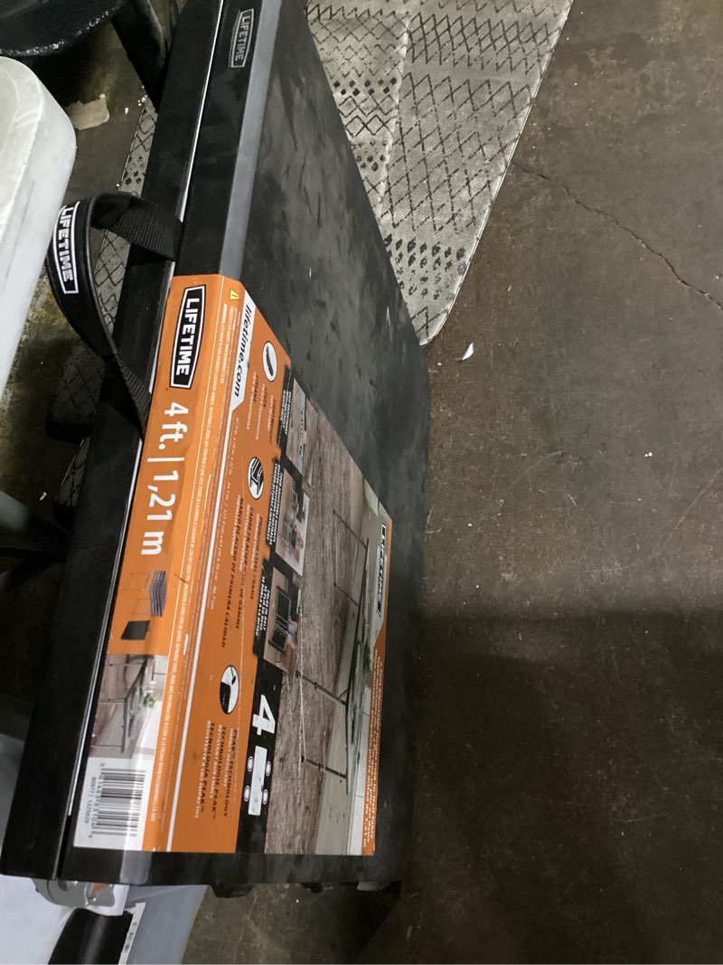 Condition photo showing Good Condition for 4 ft. one hand adjustable height fold-in-half resin table; black