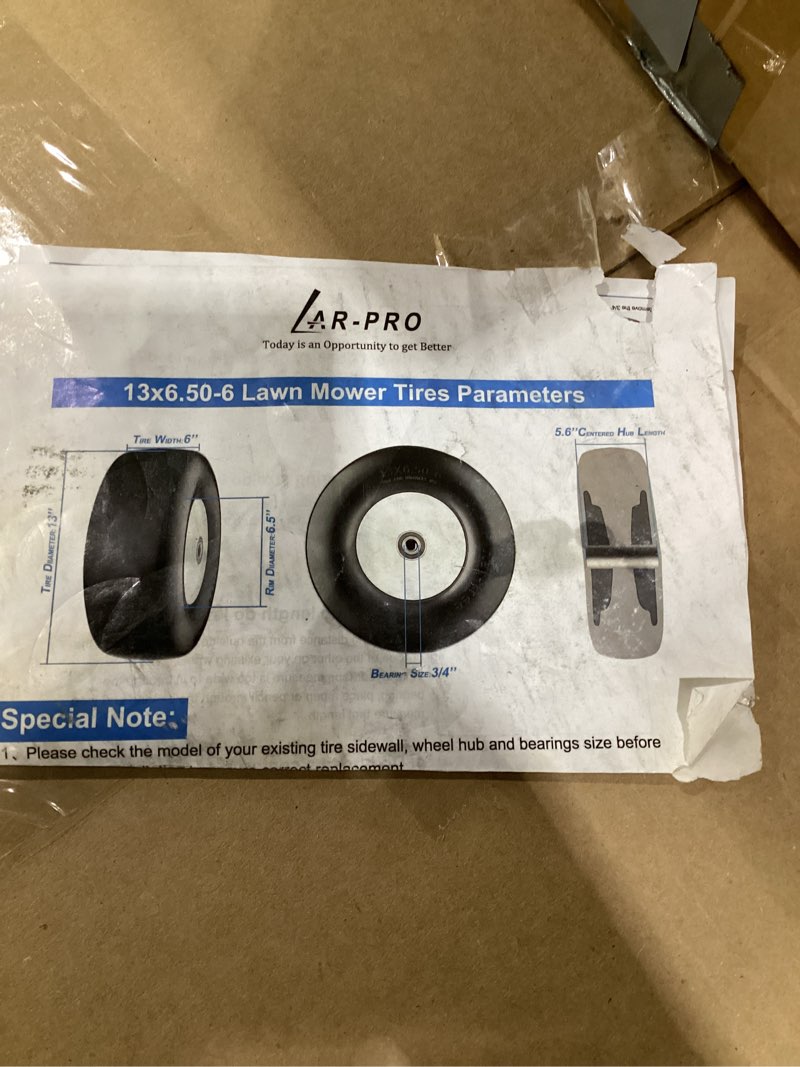 Condition photo showing As Is for lawn mower tires