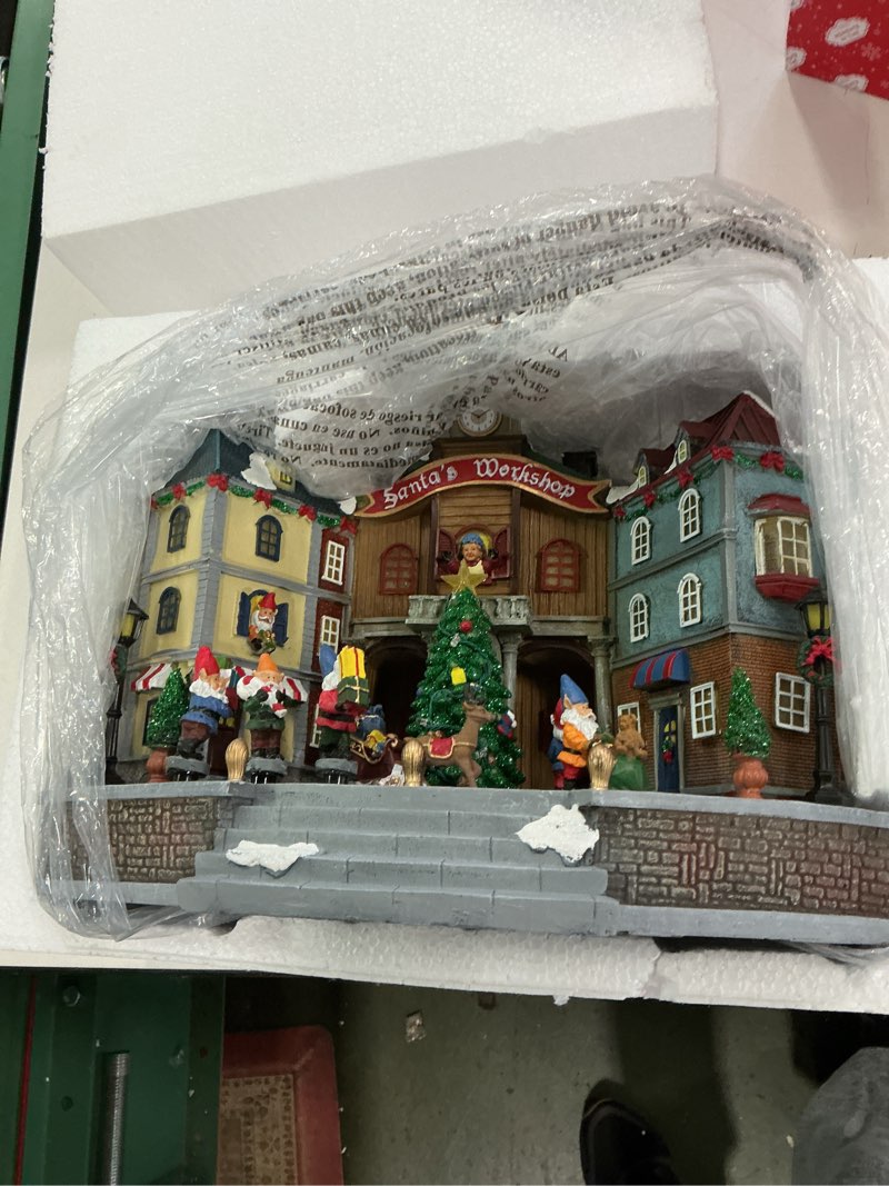 Condition photo showing Good Condition for MOMENTS IN TIME 10.83“H Animated Santa’s Workshop Town Center (Moving Tree) - LED Lights, 8 Classic Carols Christmas Music, Adapter Included Christmas Village - Hand-Painted Polyresin