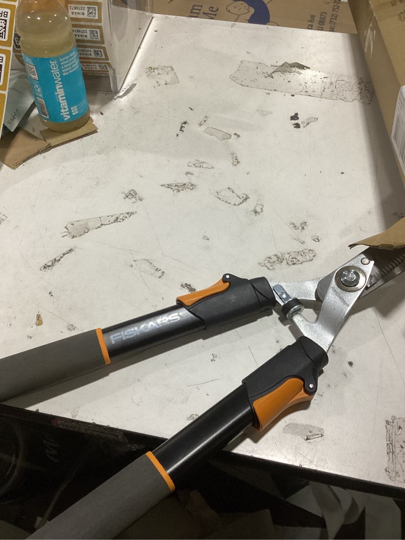 Condition photo showing As Is for fiskars power-lever extendable hedge shears, self-sharpening serrated steel blades for clean cuts, handles adjust 25"-33" for high reach, multiplies leverage for 2x power, 10" blades, orange/black 25-33" power-lever