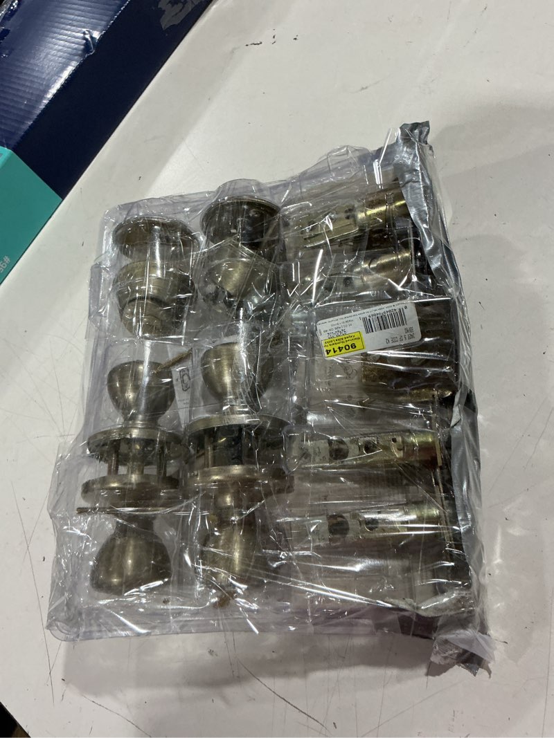Condition photo showing As Is for tylo antique brass exterior entry door knob and single cylinder deadbolt project pack