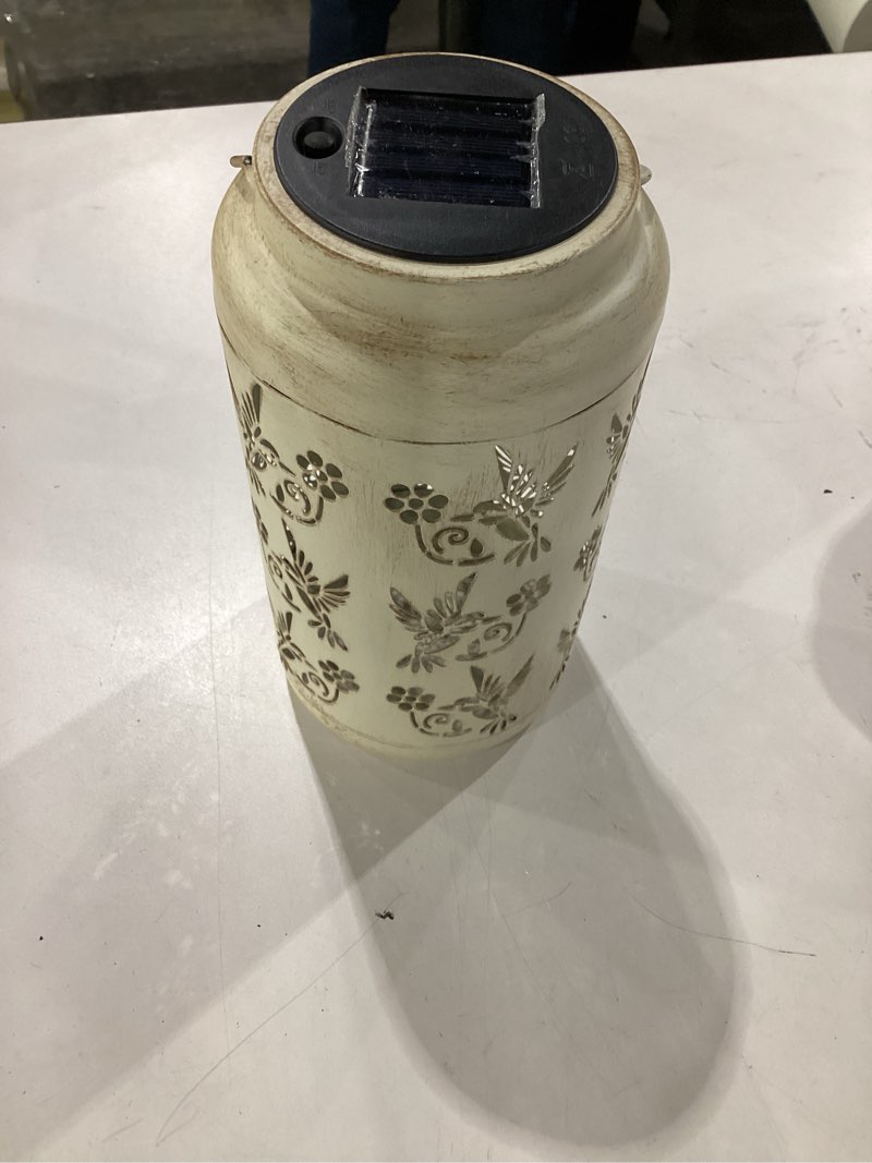 Condition photo showing As Is for bliss outdoors bsl-309-wh 9" tall 2-pack hanging and tabletop decorative solar led lantern, unique humming bird design & antique hand painted finish, outdoor, backyard, waterproof ip44, antique white