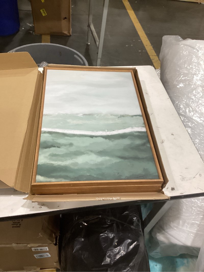 the pictured item is a coastal-themed framed canvas wall art piece depicting a serene seascape with soft green and white hues, likely similar to pieces produced by stupell industries or artist shaina page.  