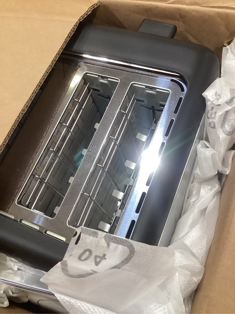 Condition photo showing As Is for amazon basics 4 slice toaster, with 7 browning settings, extra wide slots for bagels and special breads, removable easy-to-clean crumb trays, cancel/defrost/bagel buttons, 1500w, black & silver