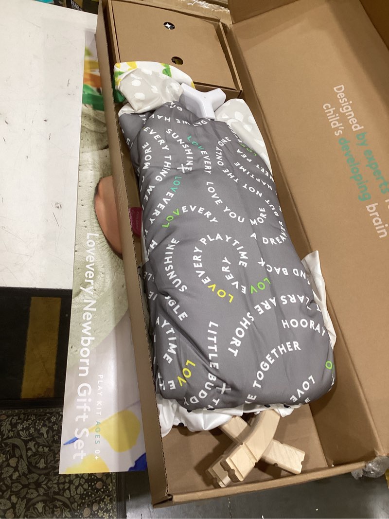 Condition photo showing As Is for lovevery, the newborn gift set, play gym with sensory strands and looker play kit, baby development essentials, ages 0+