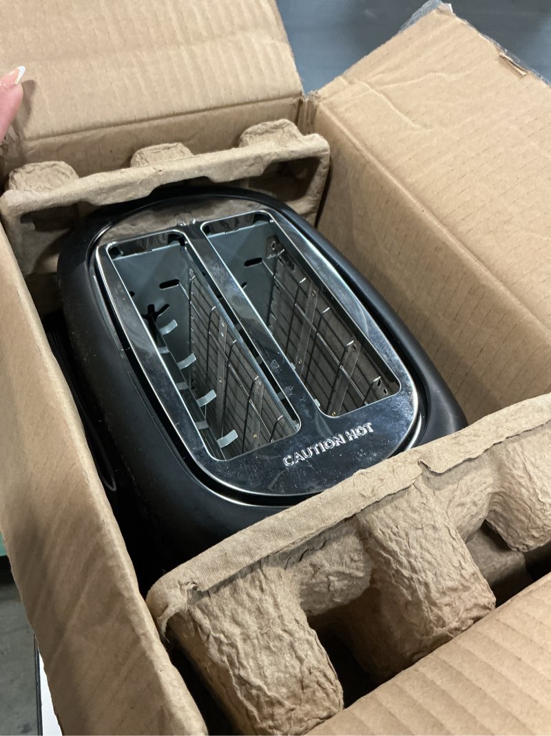 Condition photo showing As Is for Amazon Basics 2 Slice Toaster, With 6 Browning Settings, Extra Wide Slots For Bagels and Special Breads, Removable Easy-to-Clean Crumb Tray, Cancel/Defrost/Bagel Buttons, 900W, Black & Silver 2 Slice Silver Front