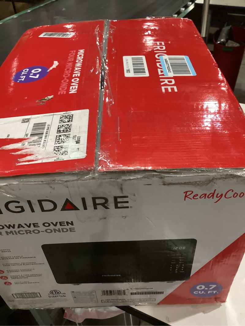Condition photo showing As Is for FRIGIDAIRE 0.7 Cu. ft. New Countertop Microwave Oven - Black