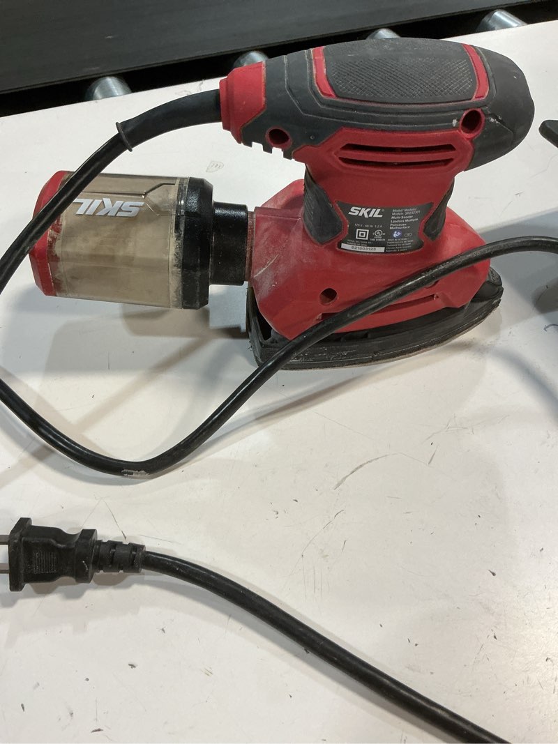 Condition photo showing As Is for skil corded multi-function detail sander with micro-filter dust box 3 additional attachments & 12pc sanding sheet- sr232301 one size multi-function detail sander