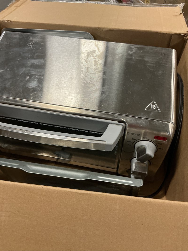 Condition photo showing As Is for BLACK+DECKER 4-Slice Toaster Oven, TO1745SSG-1A, Even Toast, 4 Cooking Functions Bake, Broil, Toast and Keep Warm, Removable Crumb Tray, Timer